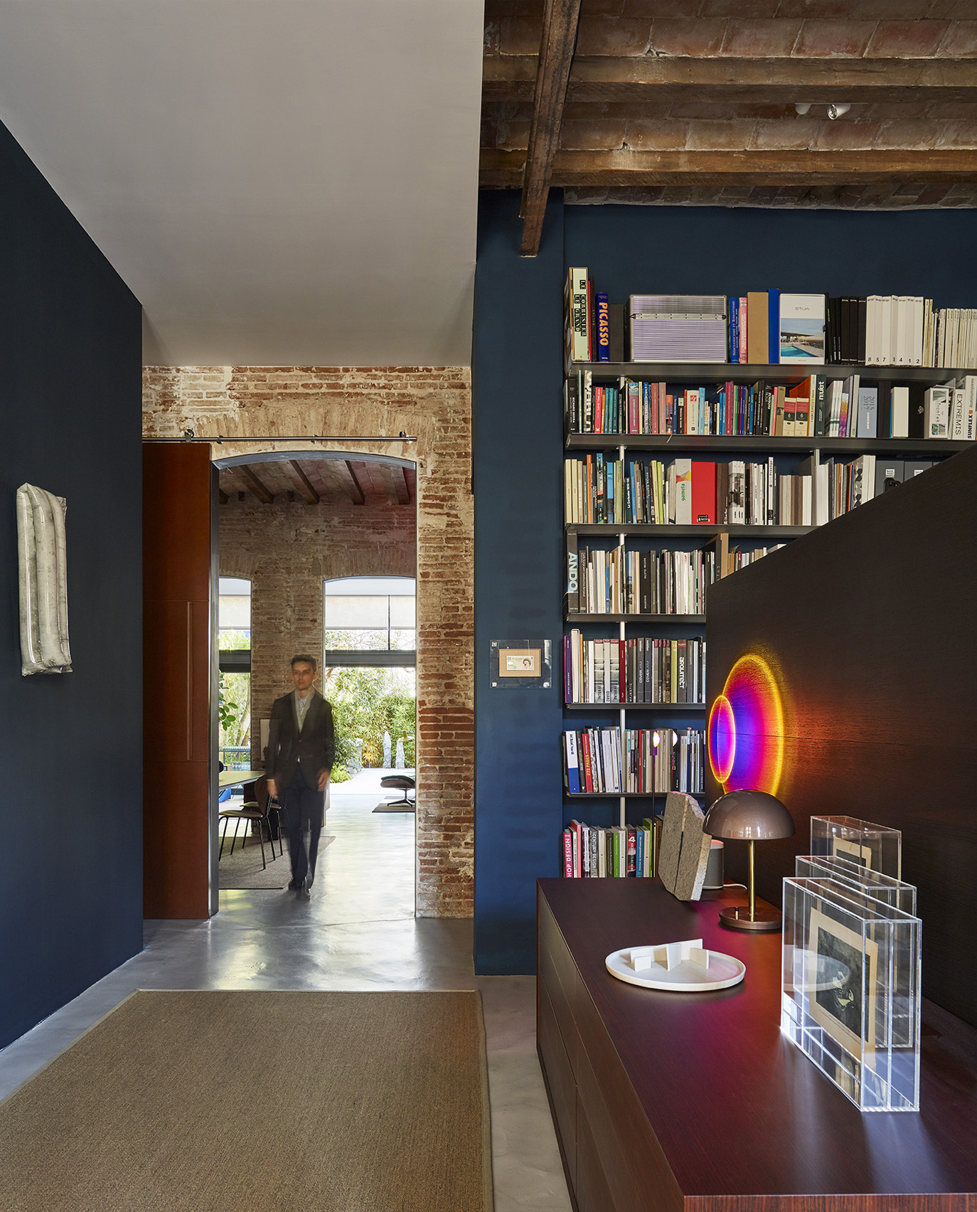 modern office space with brick walls and bookshelf