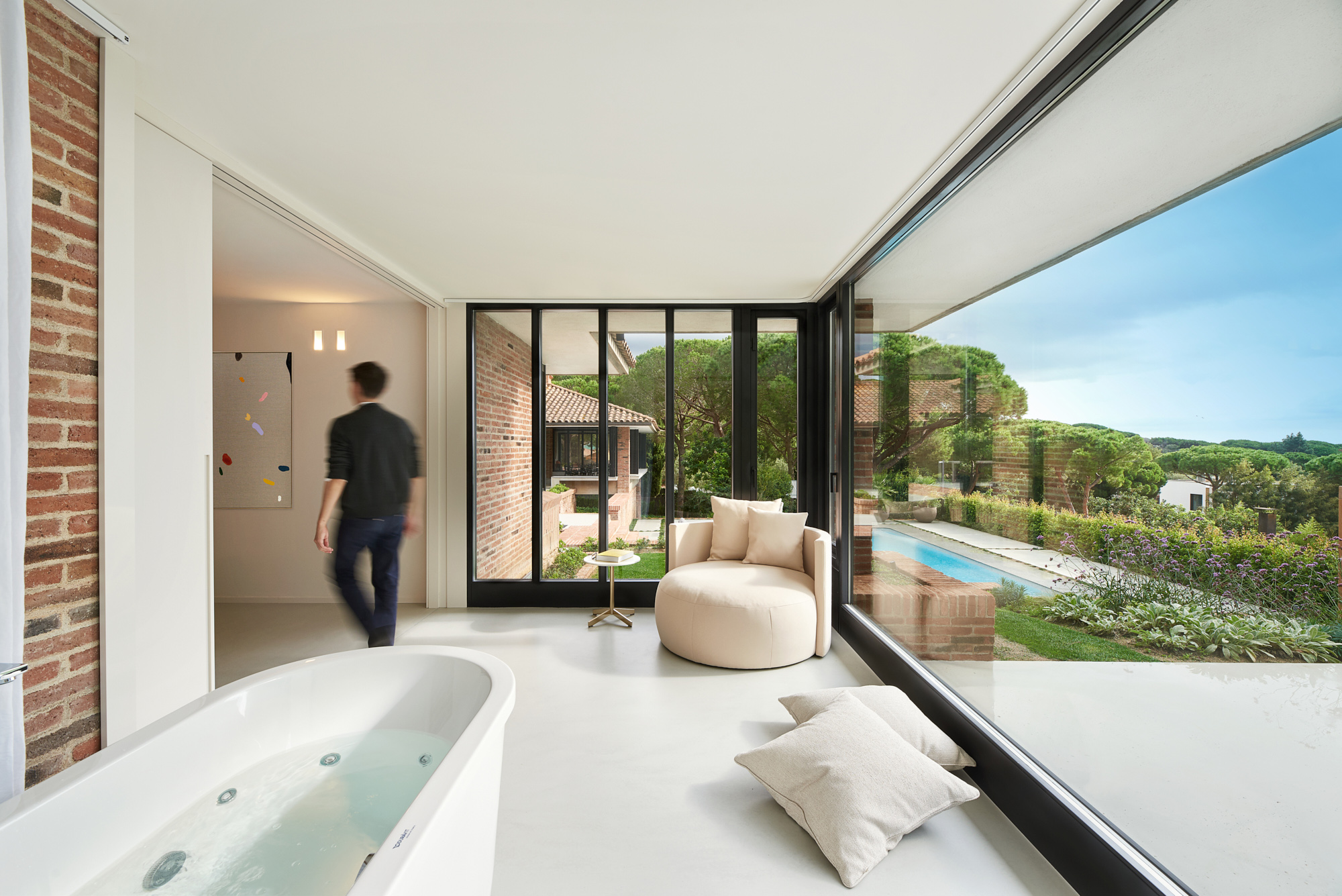 modern living space with bathtub and gardenview
