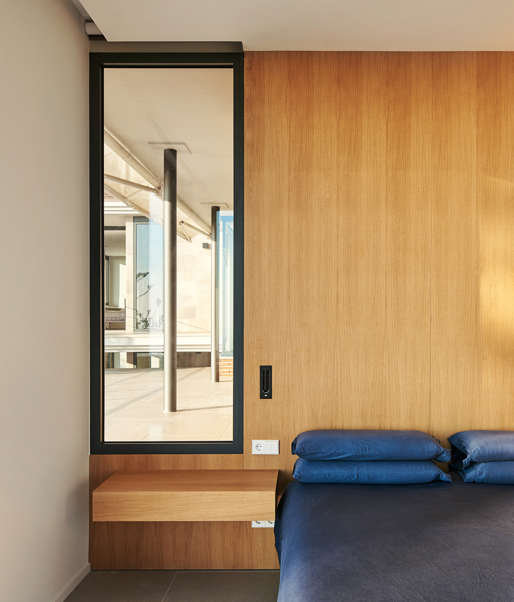 a modern bedroom detail with view on the terrace