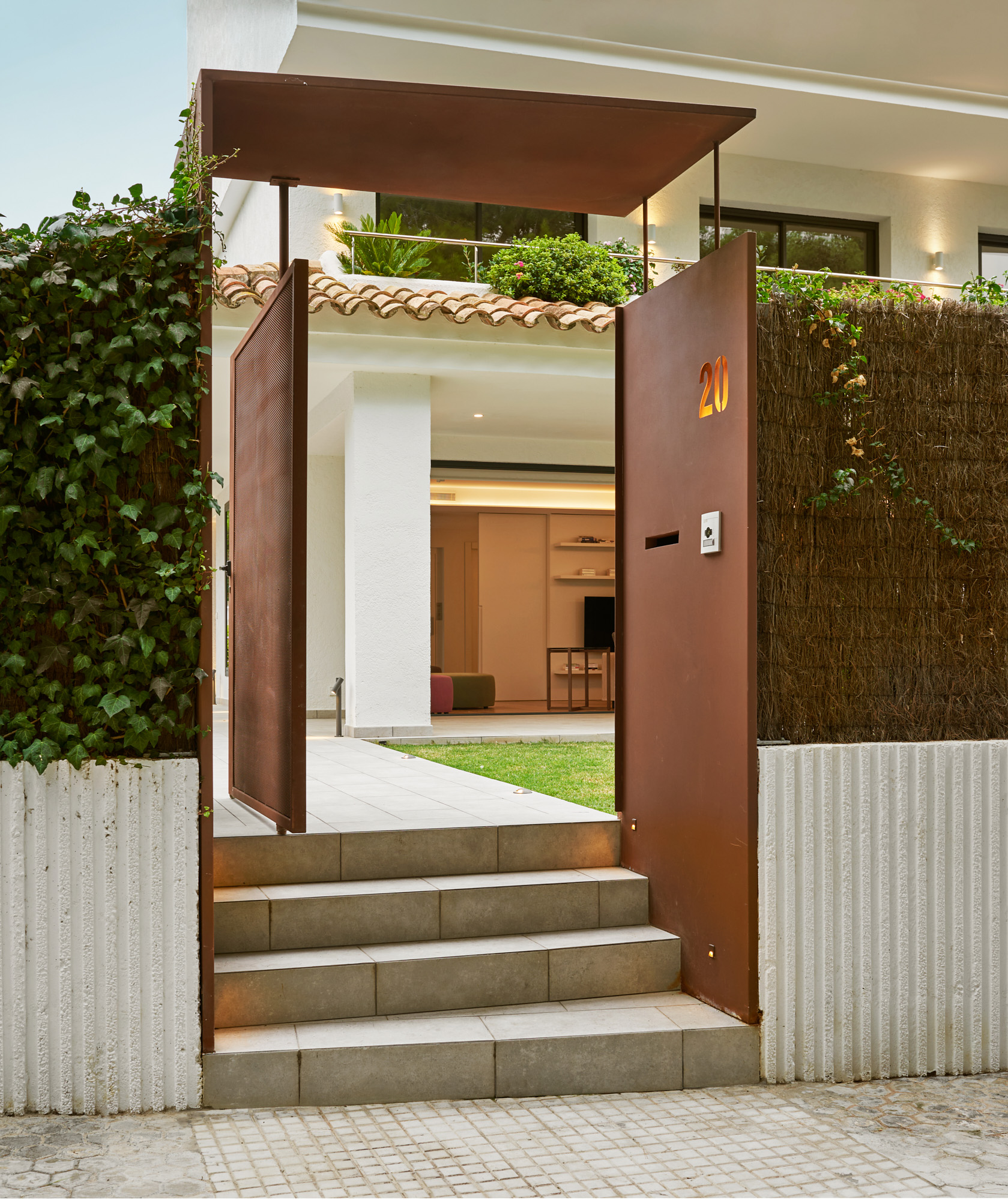modern steel entrance element in front of traditional villa
