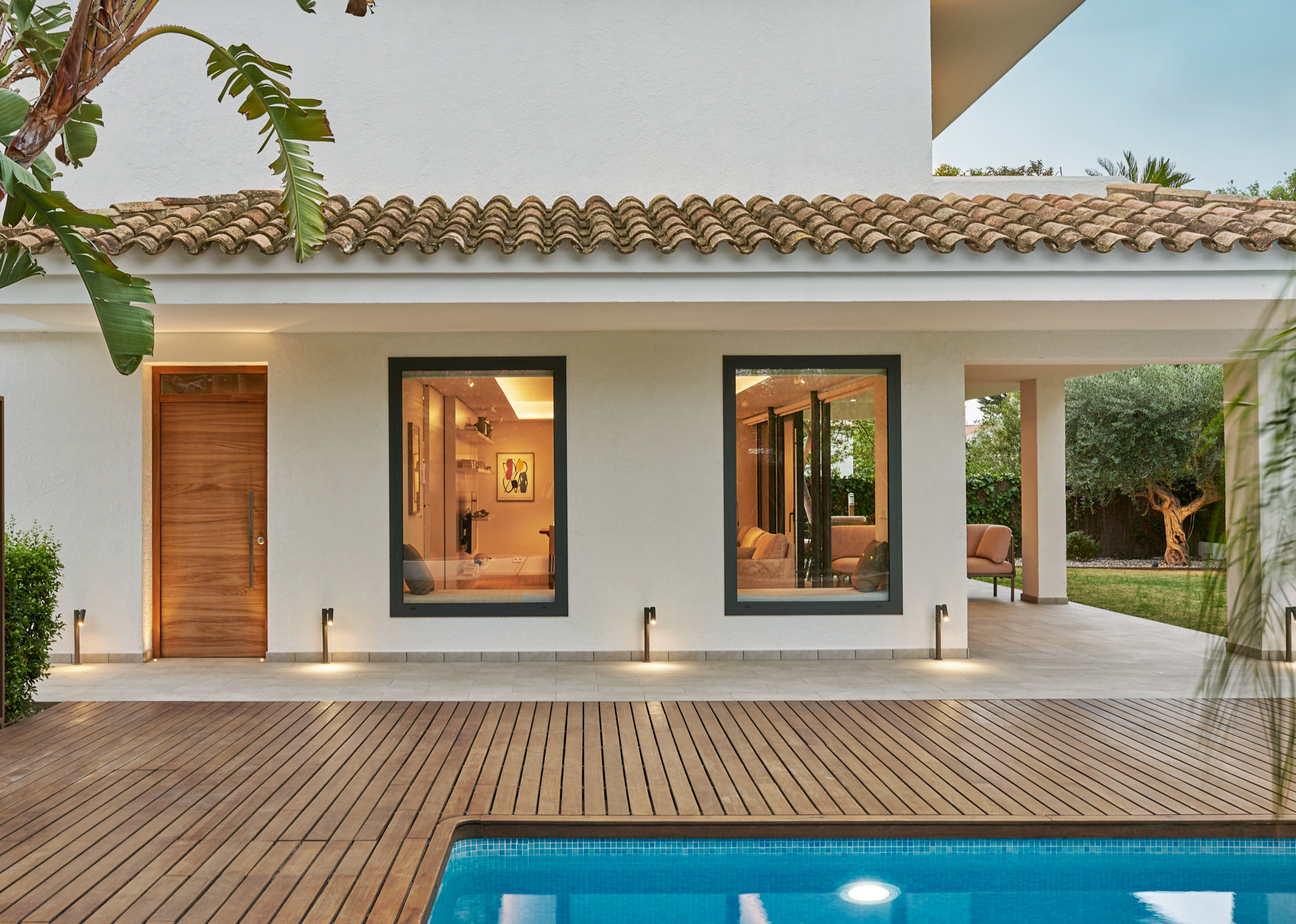 traditional villa with wooden terrace and pool